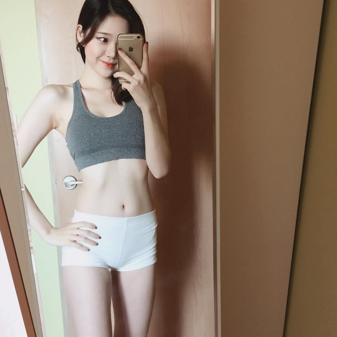 Pretty little Korean girl Soo Yun Suxeon in grey work workout top